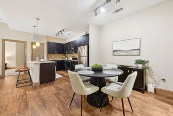 A dining room and kitchen with a table and chairs